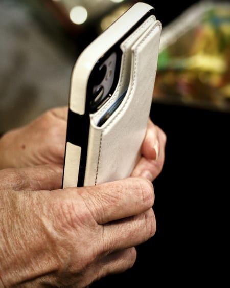 Older hands holding a phone